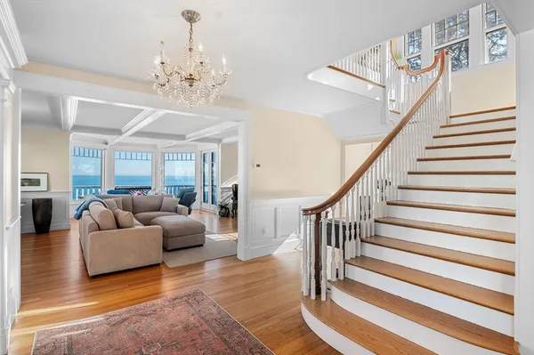 a living room with furniture and a chandelier