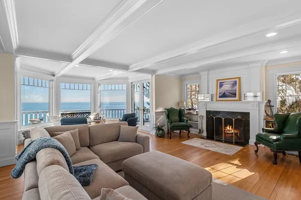 a living room with furniture large window and a fireplace