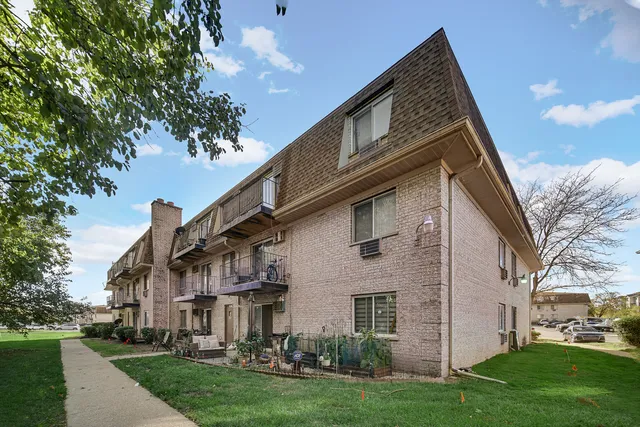 a front view of a house with a garden and plants