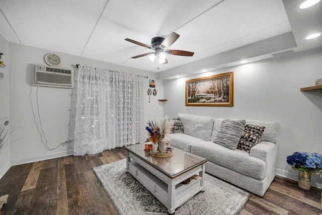 a living room with furniture and wooden floor