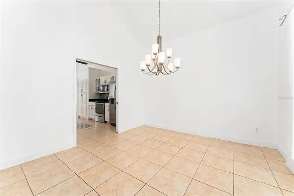 a view of an empty room with chandelier