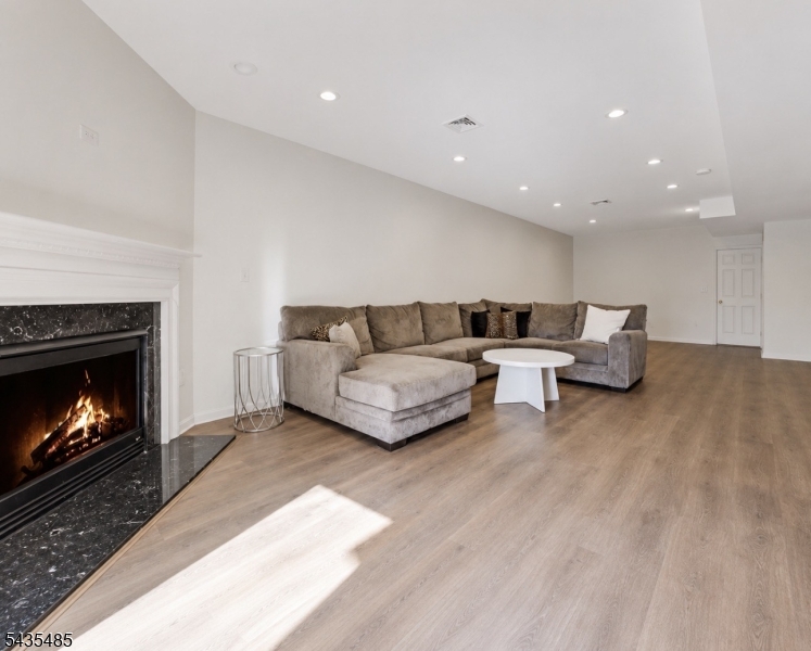 41 Chestnut Court Cedar Grove, NJ 07009 - Photo 14 of 18 a living room with furniture and a fireplace