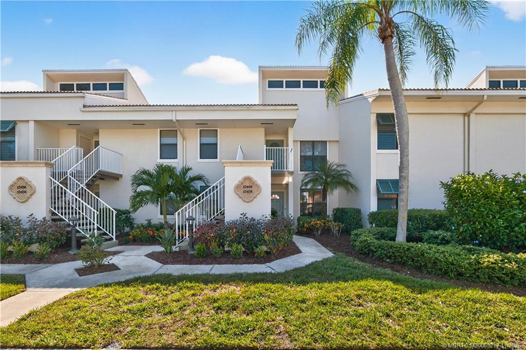 13438 Northwest Harbour Ridge Boulevard, Unit 3A Palm City, FL 34990 - Photo 1 of 19 a front view of a house with garden