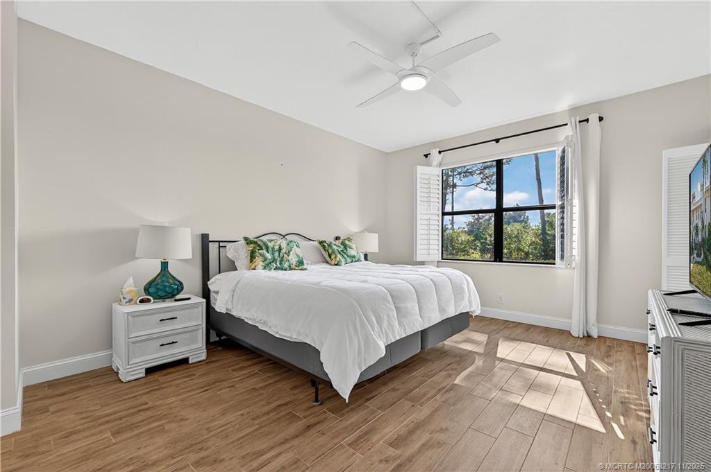 13438 Northwest Harbour Ridge Boulevard, Unit 3A Palm City, FL 34990 - Photo 12 of 19 a bedroom with a large bed and a window