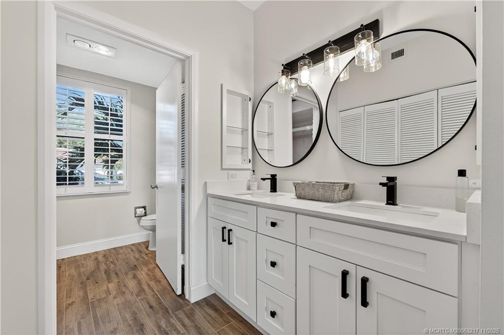 13438 Northwest Harbour Ridge Boulevard, Unit 3A Palm City, FL 34990 - Photo 14 of 19 a bathroom with a sink and a mirror