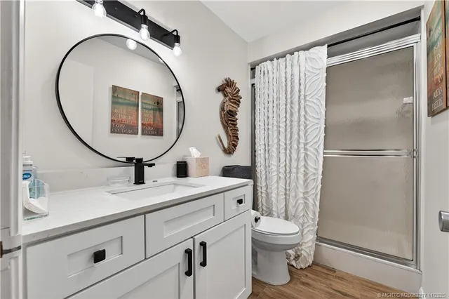 a bathroom with a toilet a sink and a mirror