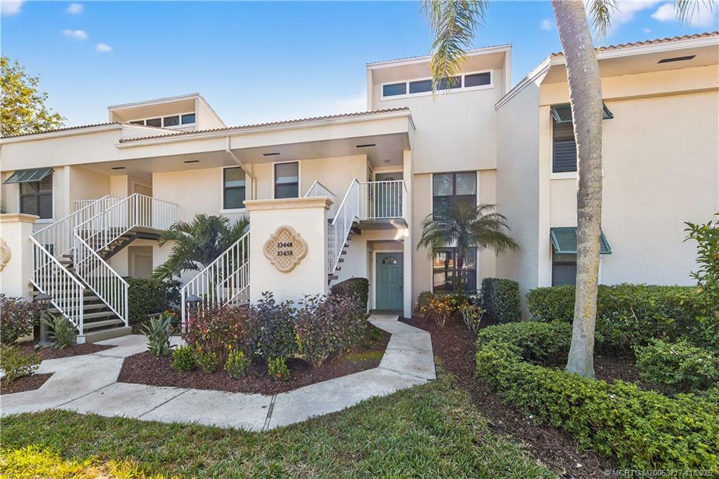 13438 Northwest Harbour Ridge Boulevard, Unit 3A Palm City, FL 34990 - Photo 2 of 19 a front view of a house with a yard