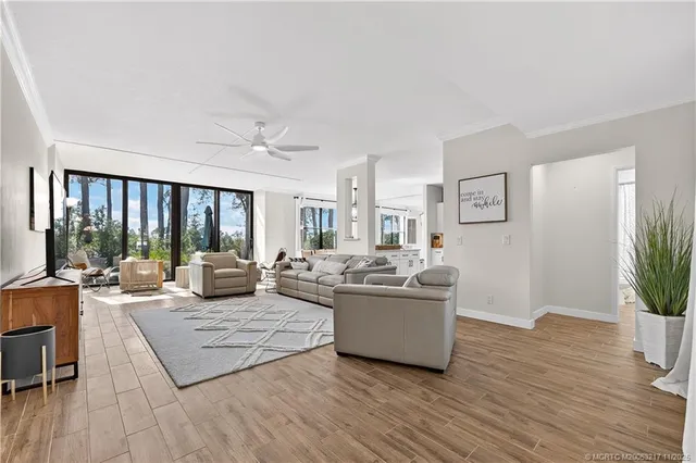 a living room with fireplace furniture and a large window