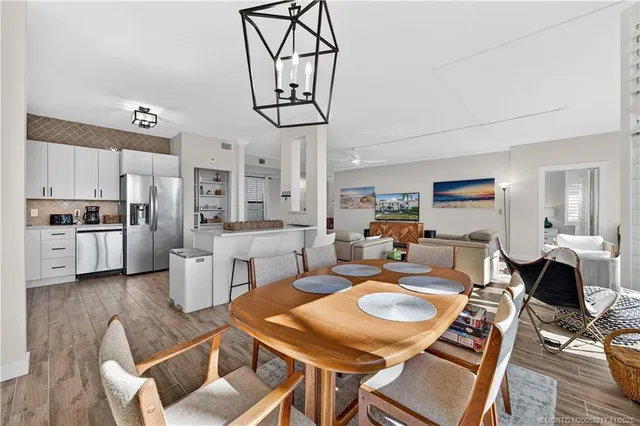 a living room with furniture a dining table and kitchen view