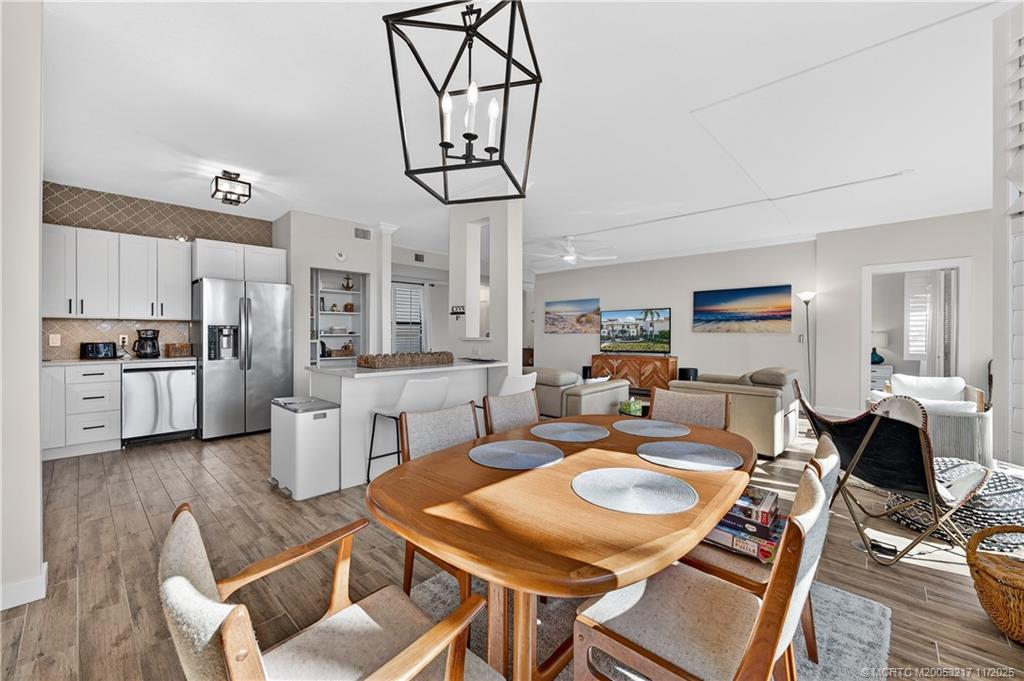 13438 Northwest Harbour Ridge Boulevard, Unit 3A Palm City, FL 34990 - Photo 7 of 19 a living room with furniture a dining table and kitchen view