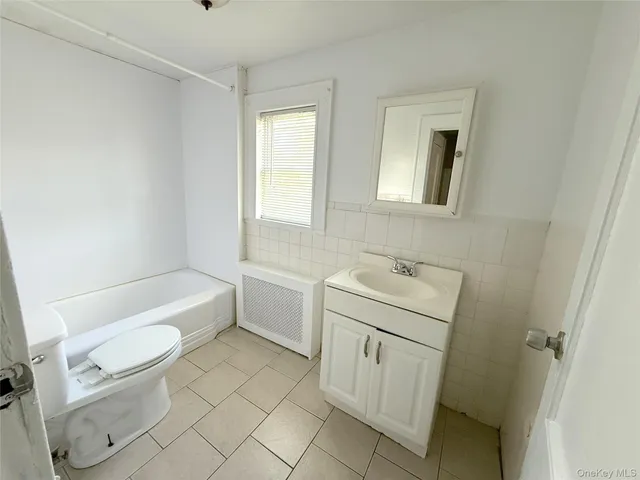 a bathroom with a sink a toilet and a bathtub