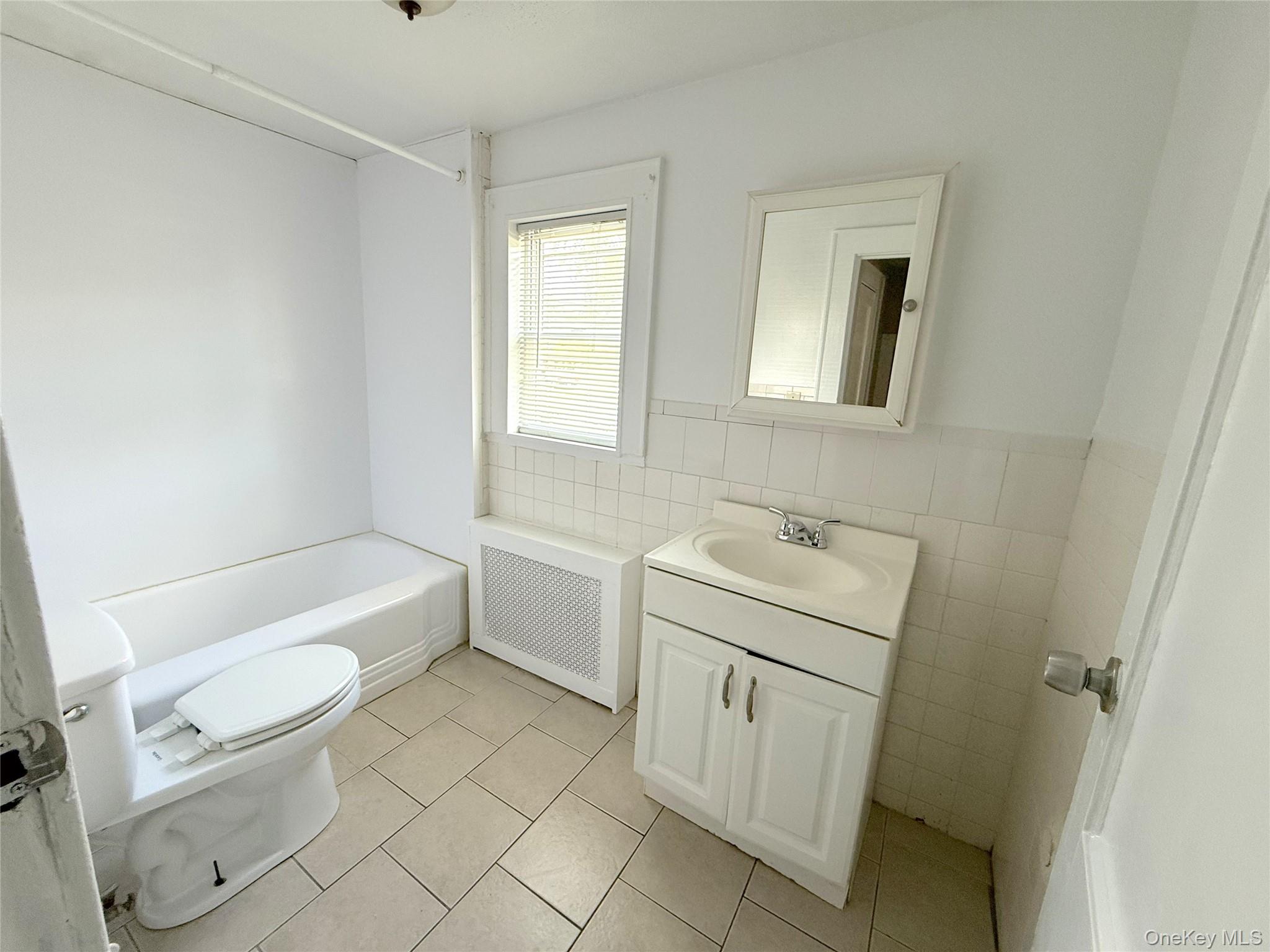 135 Ramapo Road Garnerville, NY 10923 - Photo 11 of 15 a bathroom with a sink a toilet and a bathtub