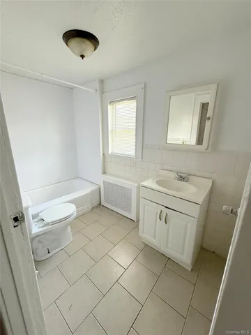 a bathroom with a sink a toilet and a tub