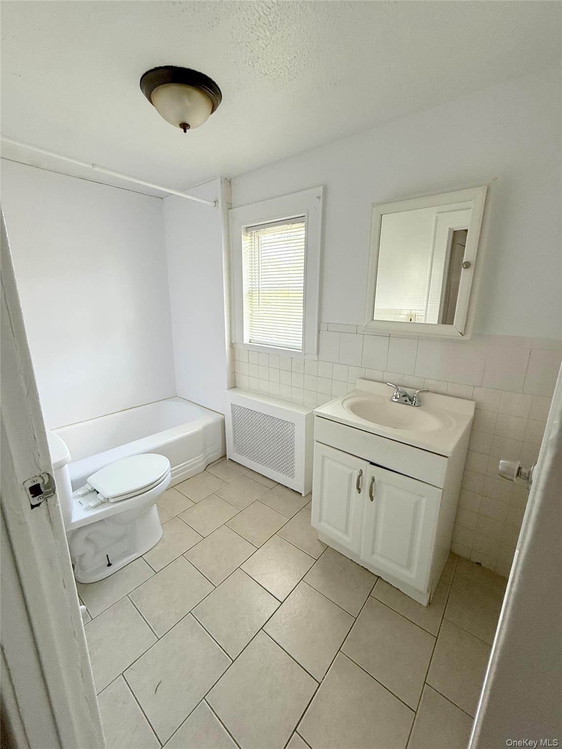 135 Ramapo Road Garnerville, NY 10923 - Photo 12 of 15 a bathroom with a sink a toilet and a tub