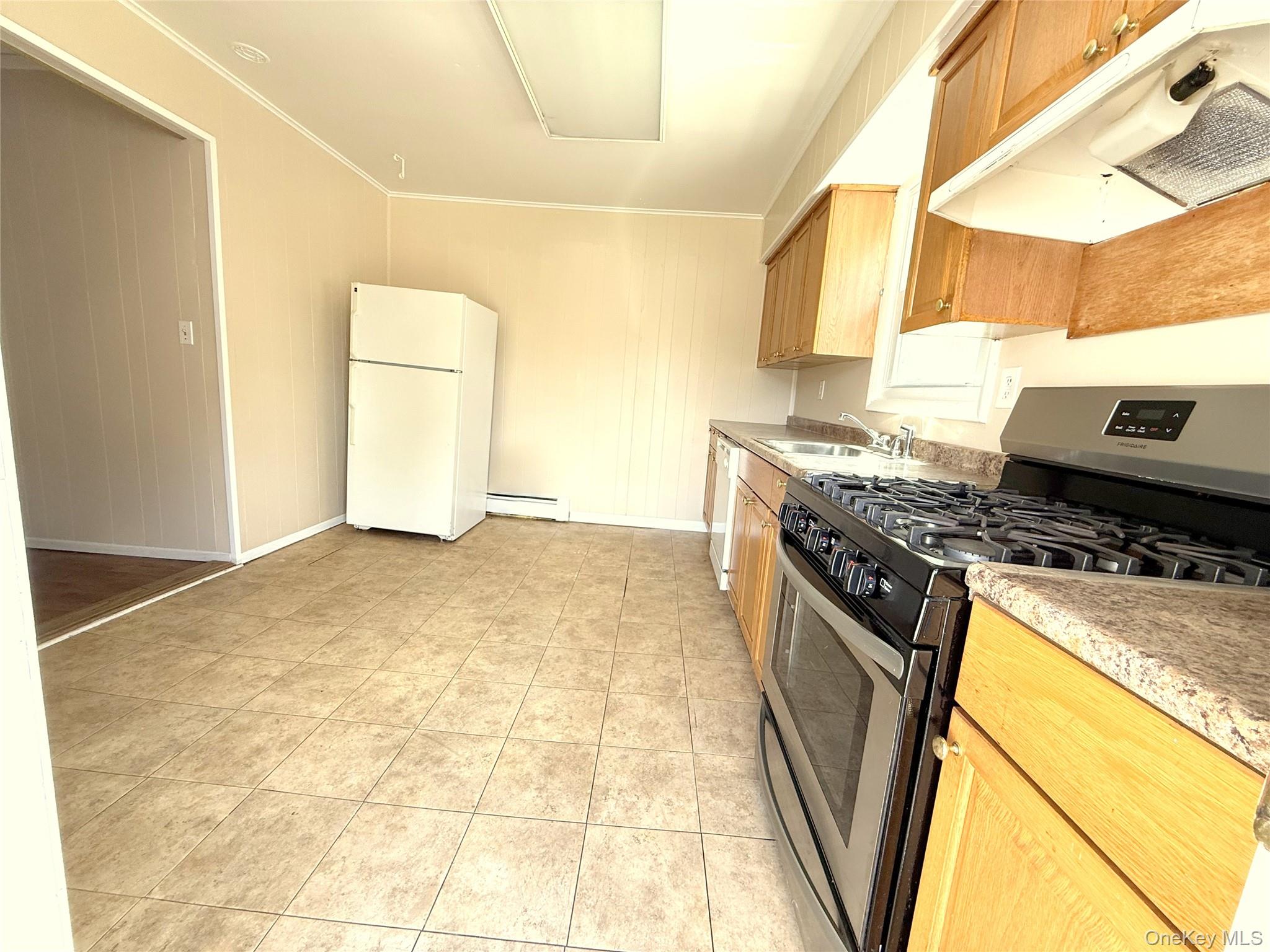 135 Ramapo Road Garnerville, NY 10923 - Photo 2 of 15 a kitchen with granite countertop a stove a sink and a refrigerator