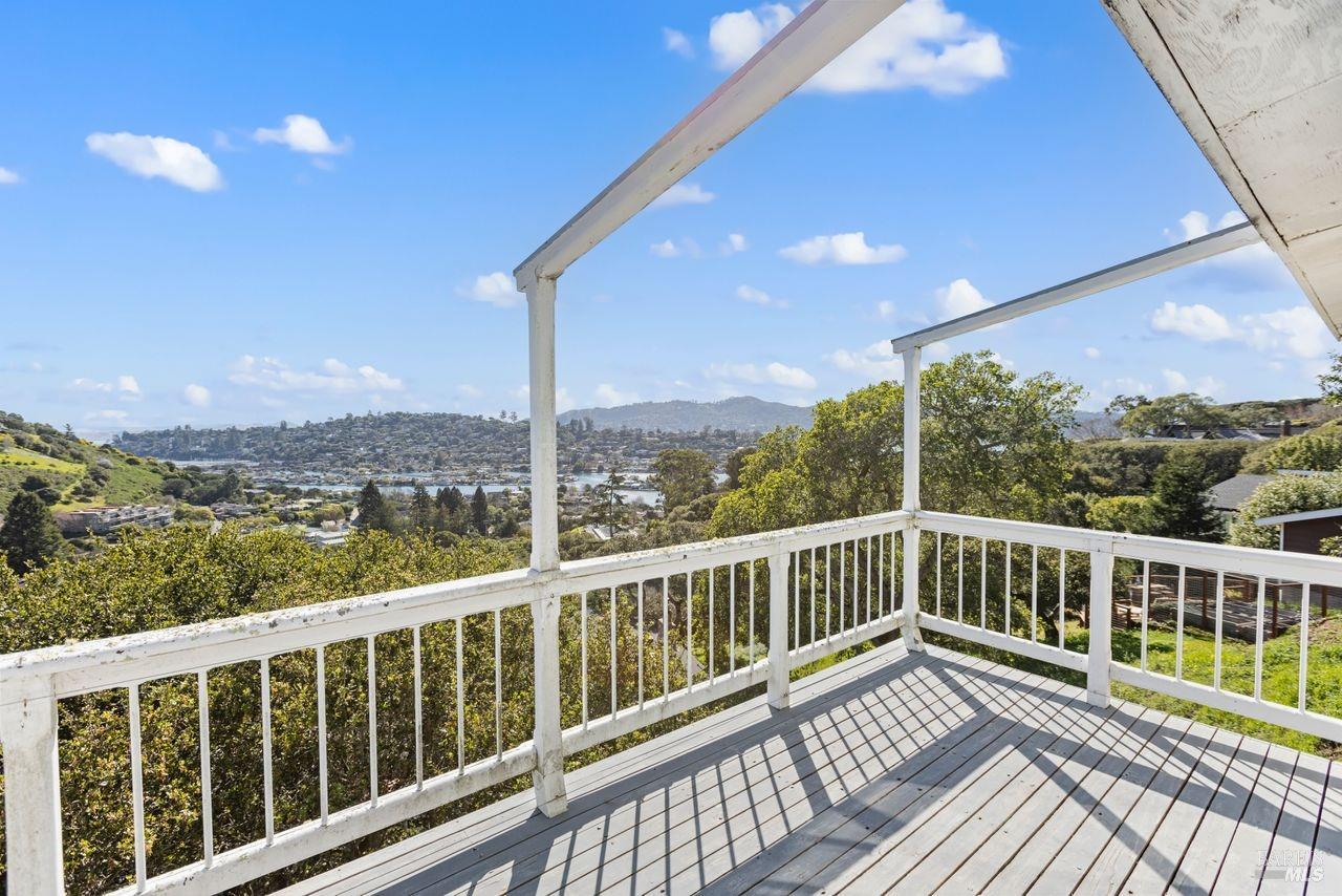 a view of a two chairs in the balcony