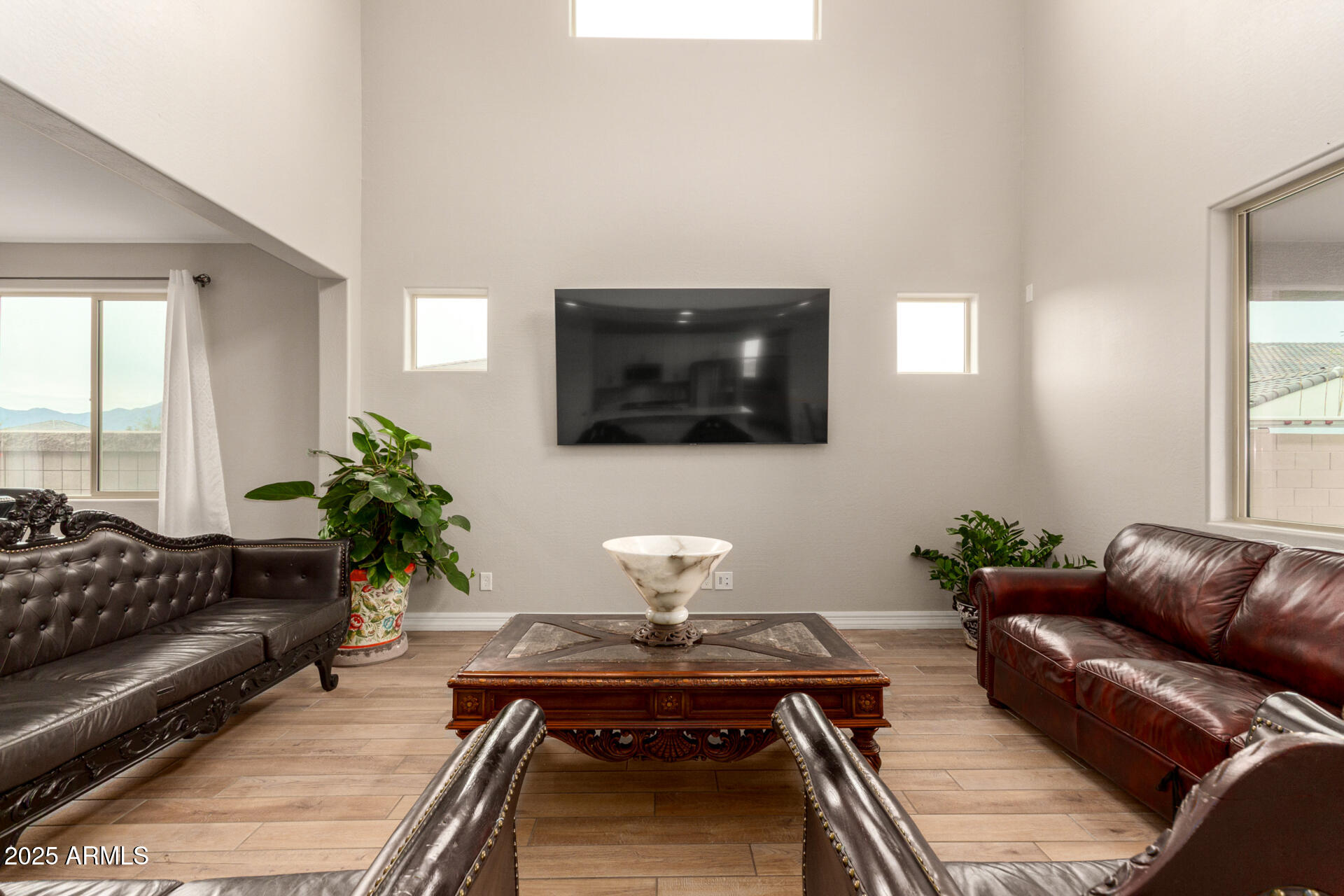 5126 West Roundhouse Road Laveen, AZ 85339 - Photo 12 of 39 a living room with furniture and a flat screen tv