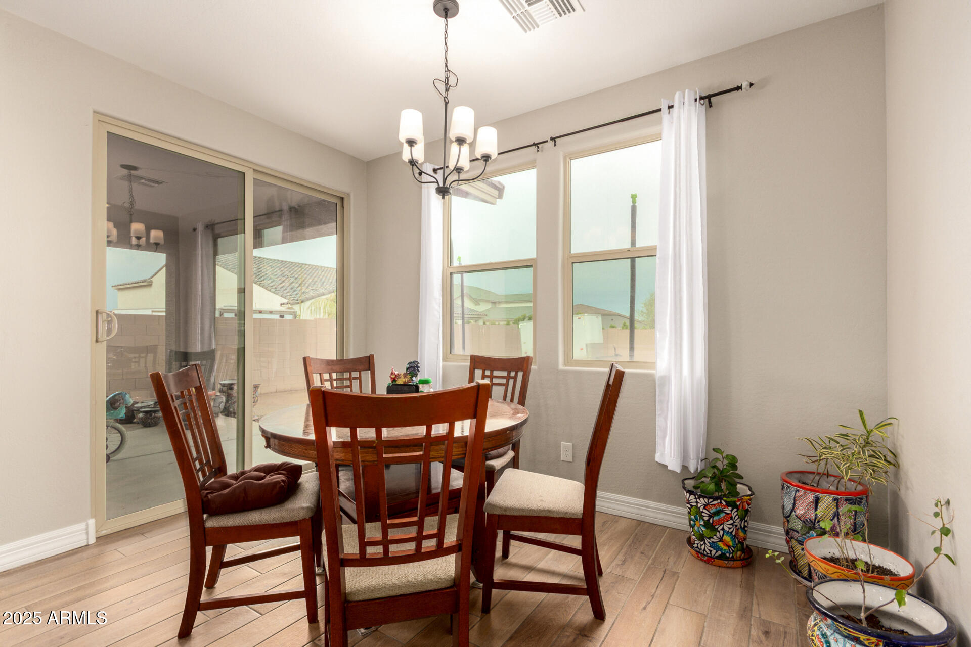 5126 West Roundhouse Road Laveen, AZ 85339 - Photo 14 of 39 a dining room with furniture window and wooden floor