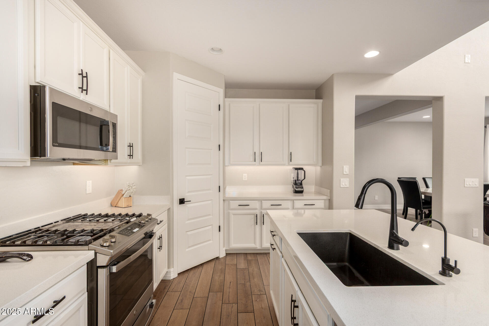 5126 West Roundhouse Road Laveen, AZ 85339 - Photo 17 of 39 a kitchen with stainless steel appliances granite countertop a sink stove and refrigerator