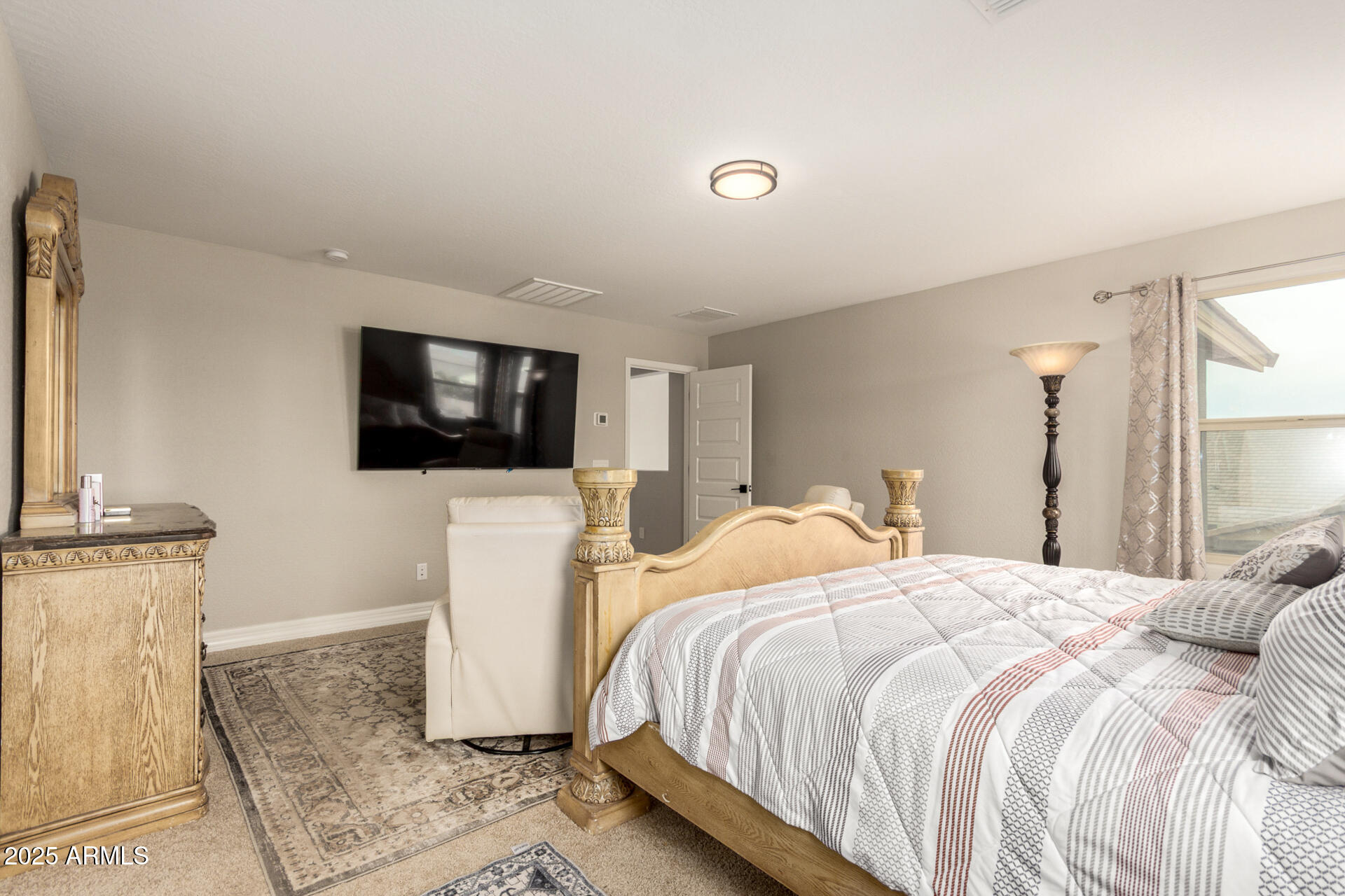 5126 West Roundhouse Road Laveen, AZ 85339 - Photo 20 of 39 a bedroom with a bed and a television