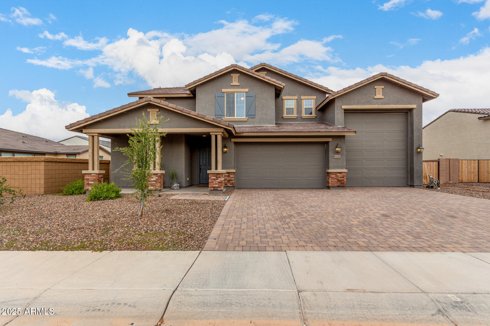 5126 West Roundhouse Road Laveen, AZ 85339 - Photo 2 of 39 a front view of a house with a yard and garage