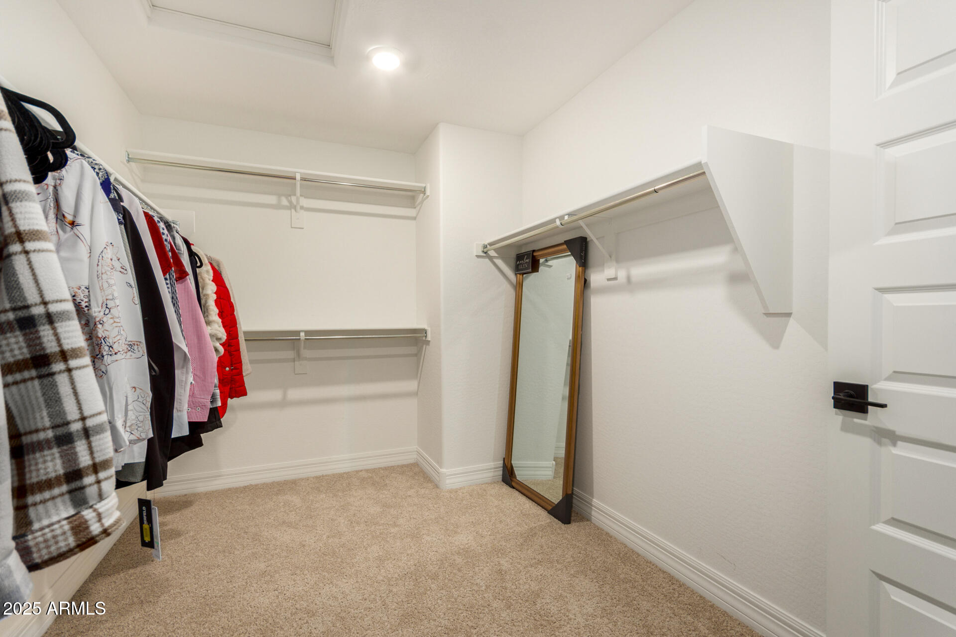 5126 West Roundhouse Road Laveen, AZ 85339 - Photo 26 of 39 a view of walk in closet with clothes
