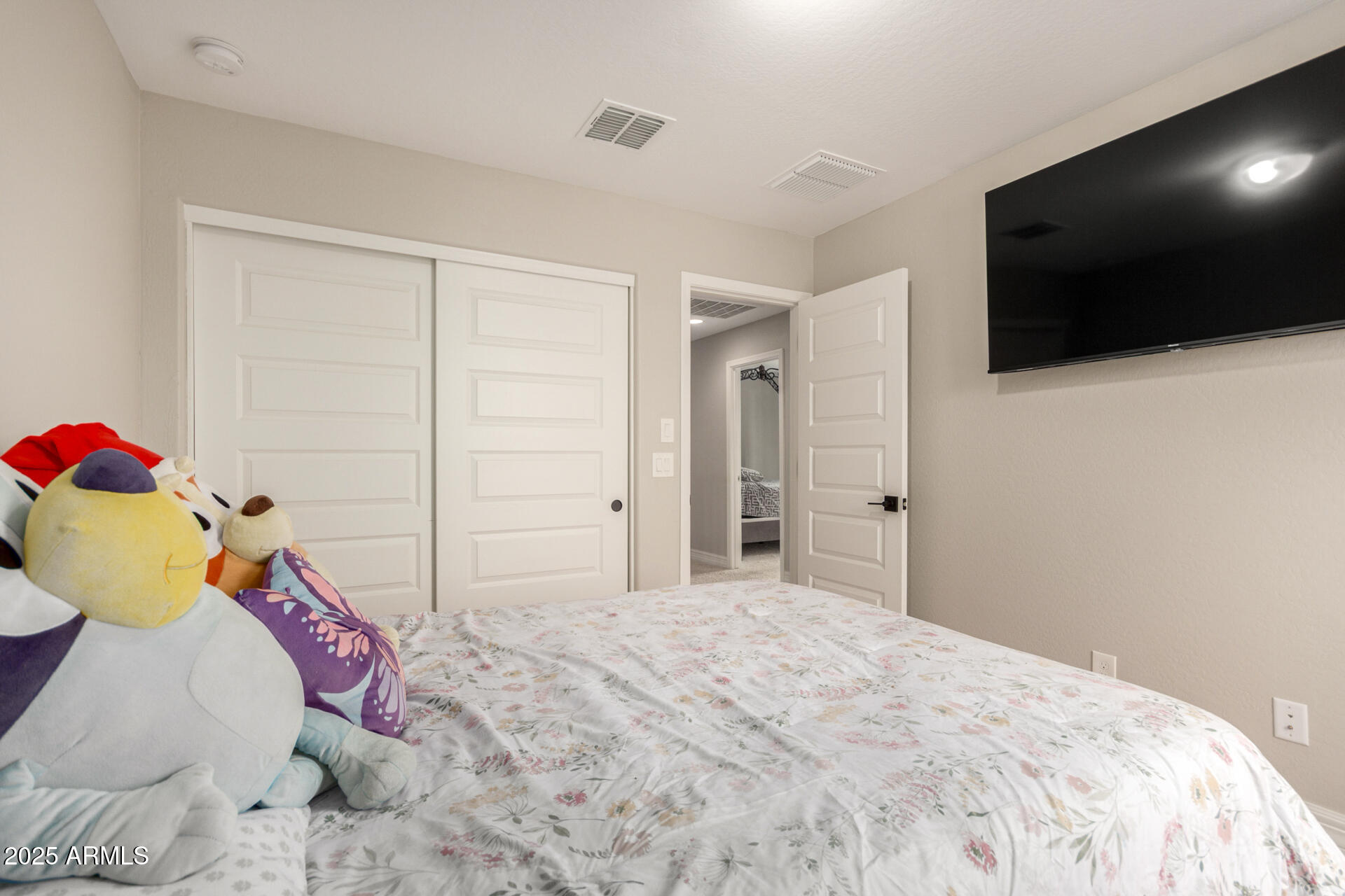 5126 West Roundhouse Road Laveen, AZ 85339 - Photo 28 of 39 a bedroom with a bed and flat screen tv