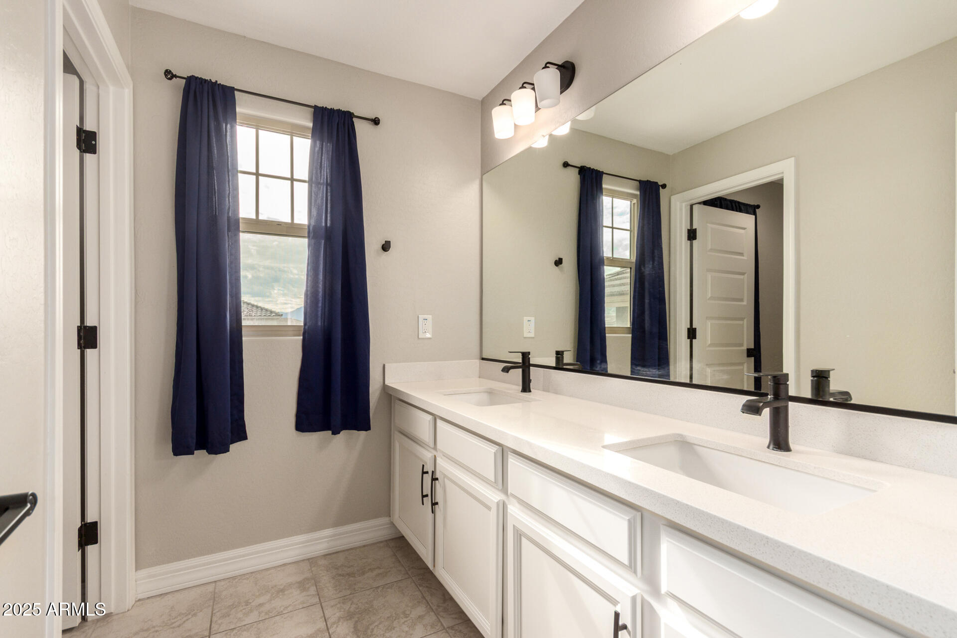 5126 West Roundhouse Road Laveen, AZ 85339 - Photo 32 of 39 a bathroom with a sink and a mirror