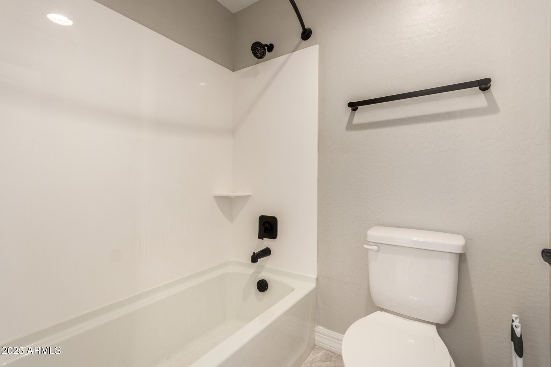 5126 West Roundhouse Road Laveen, AZ 85339 - Photo 33 of 39 a white toilet sitting next to a bath tub