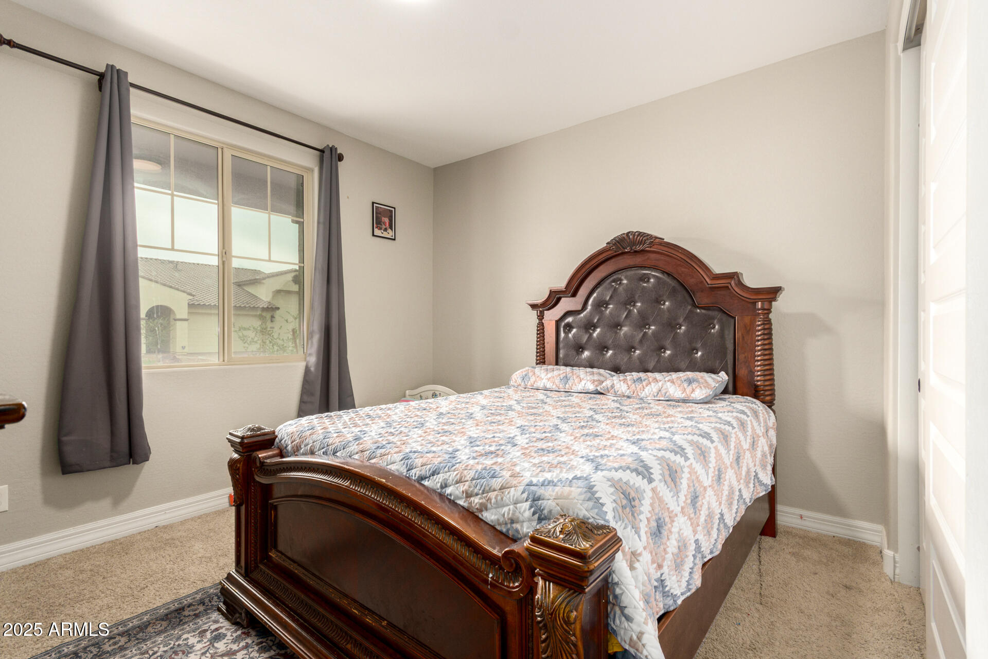 5126 West Roundhouse Road Laveen, AZ 85339 - Photo 34 of 39 a bedroom with a bed and a window