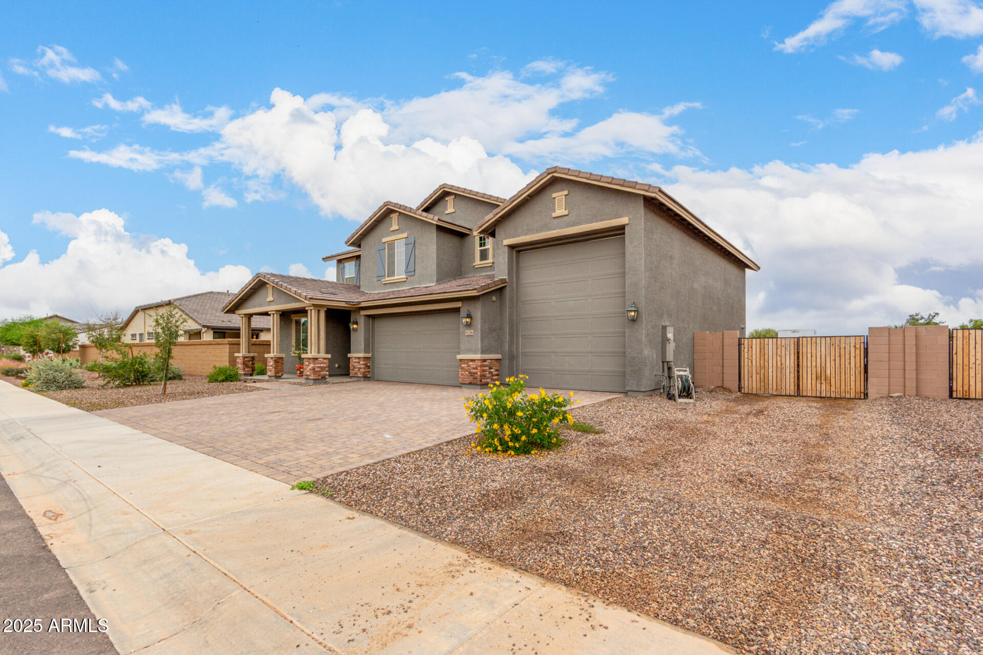 5126 West Roundhouse Road Laveen, AZ 85339 - Photo 6 of 39 a front view of a house with a yard and garage