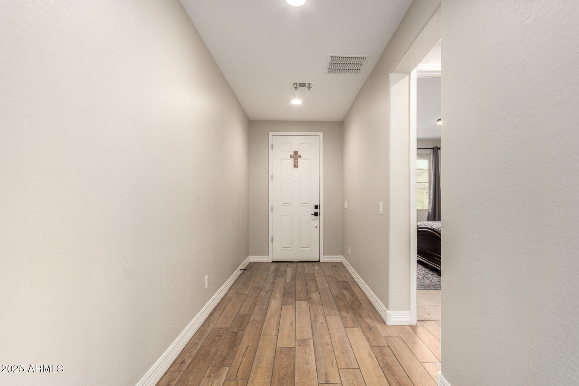 5126 West Roundhouse Road Laveen, AZ 85339 - Photo 8 of 39 a view of a hallway with wooden floor and a bathroom