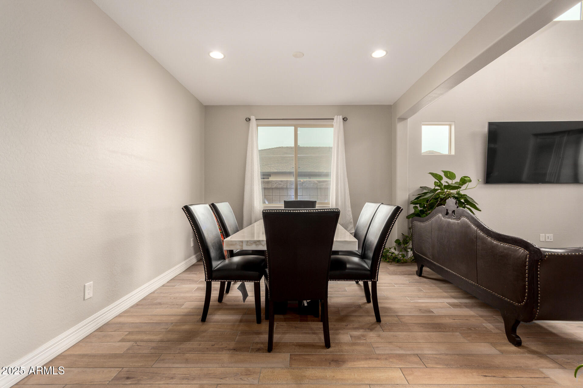 5126 West Roundhouse Road Laveen, AZ 85339 - Photo 10 of 39 a view of a dining room with furniture window and wooden floor