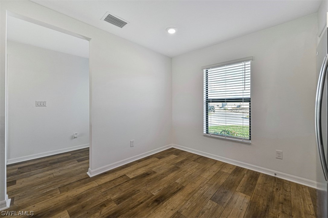 880 General Chesty Puller Court LaBelle, FL 33935 - Photo 11 of 21 an empty room with wooden floor and windows