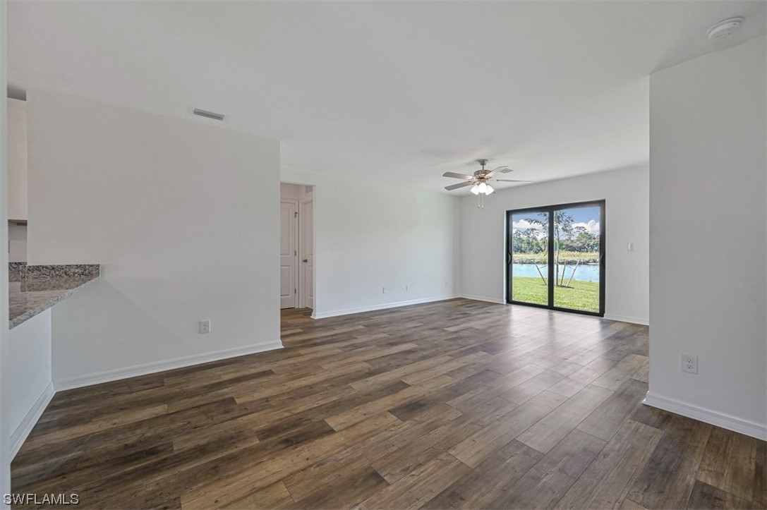 880 General Chesty Puller Court LaBelle, FL 33935 - Photo 3 of 21 a view of an empty room with wooden floor and a window
