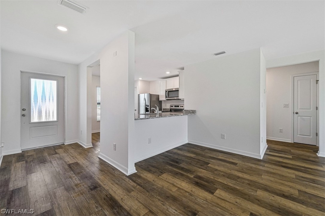 880 General Chesty Puller Court LaBelle, FL 33935 - Photo 6 of 21 a view of a kitchen with wooden floor and a sink