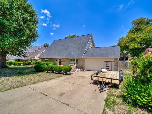 a backyard of a house with table and chairs