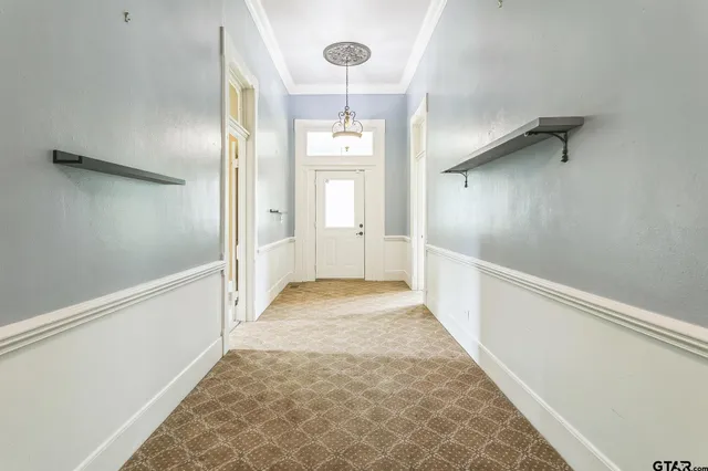 an empty room with windows and bathroom view