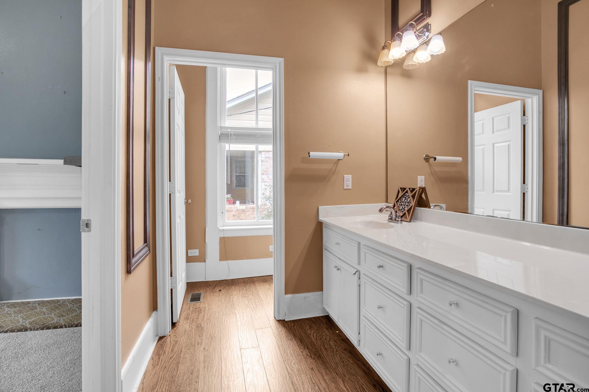 293 South Barron Rusk, TX 75785 - Photo 20 of 30 a spacious bathroom with a double vanity sink a mirror and a shower