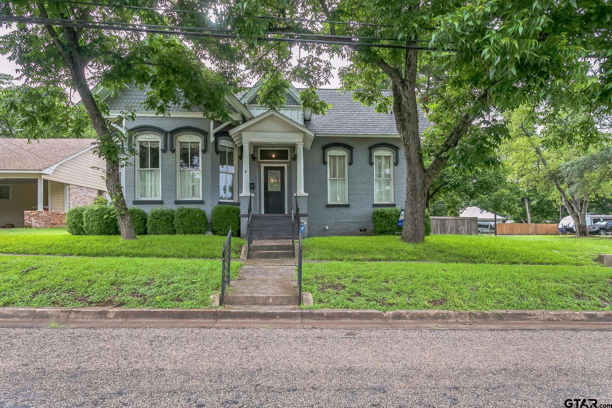 293 South Barron Rusk, TX 75785 - Photo 2 of 30 a front view of a house with a garden