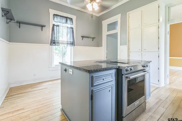 a kitchen with granite countertop white cabinets and white appliances