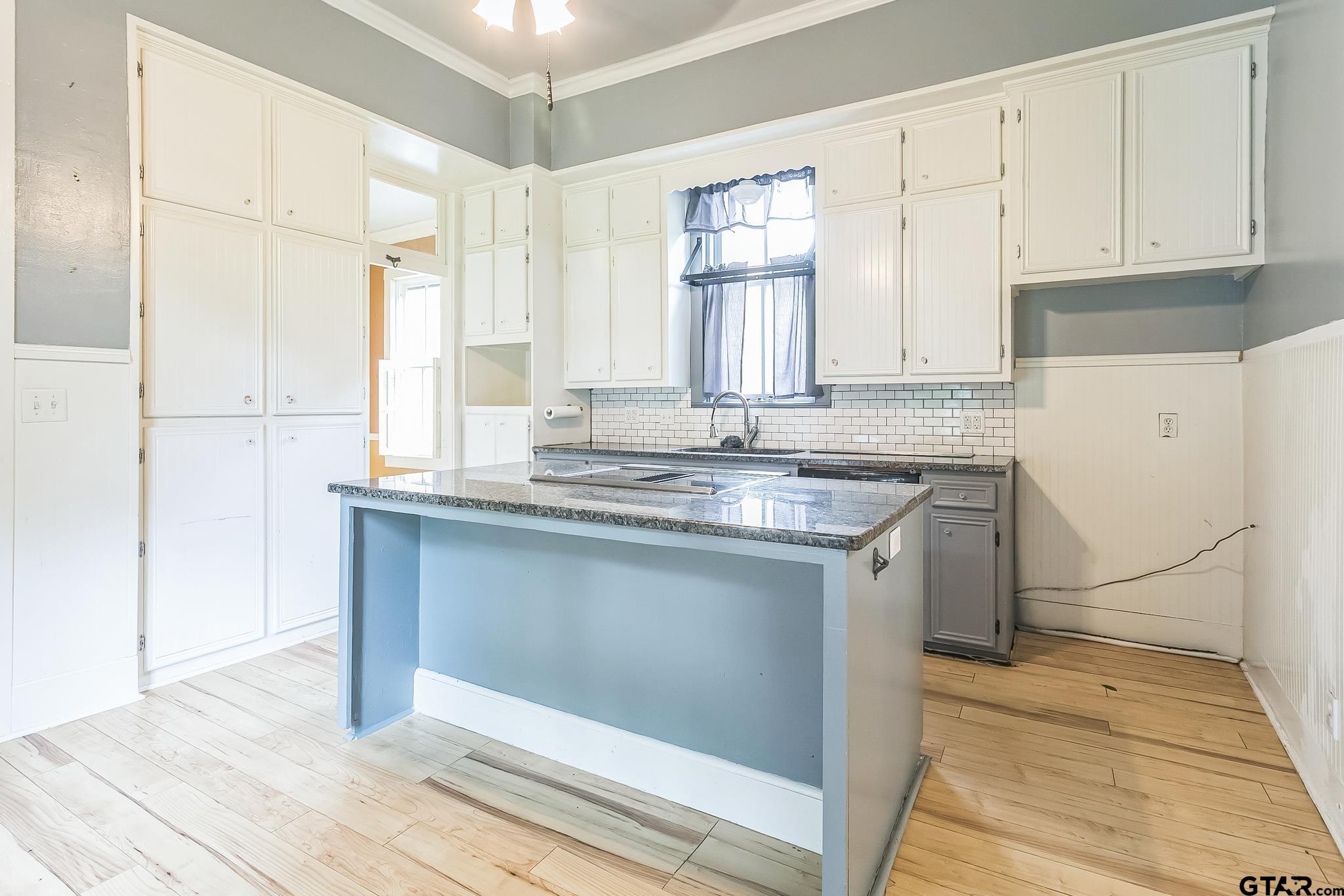 293 South Barron Rusk, TX 75785 - Photo 24 of 30 a kitchen with granite countertop white cabinets and white appliances