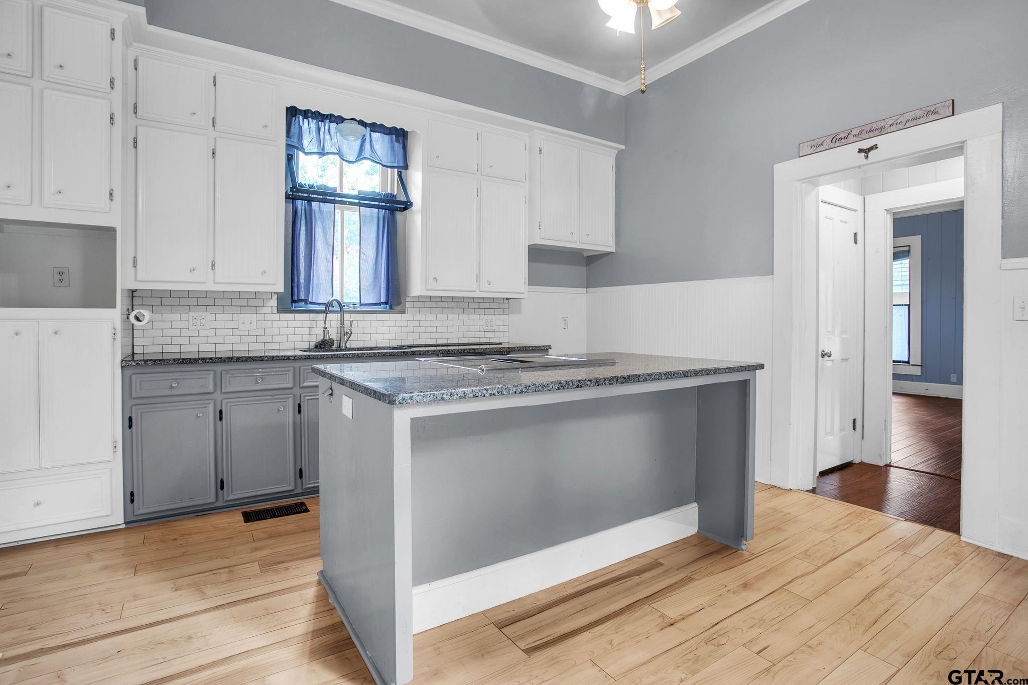 293 South Barron Rusk, TX 75785 - Photo 25 of 30 a kitchen with granite countertop a stove cabinets and wooden floor