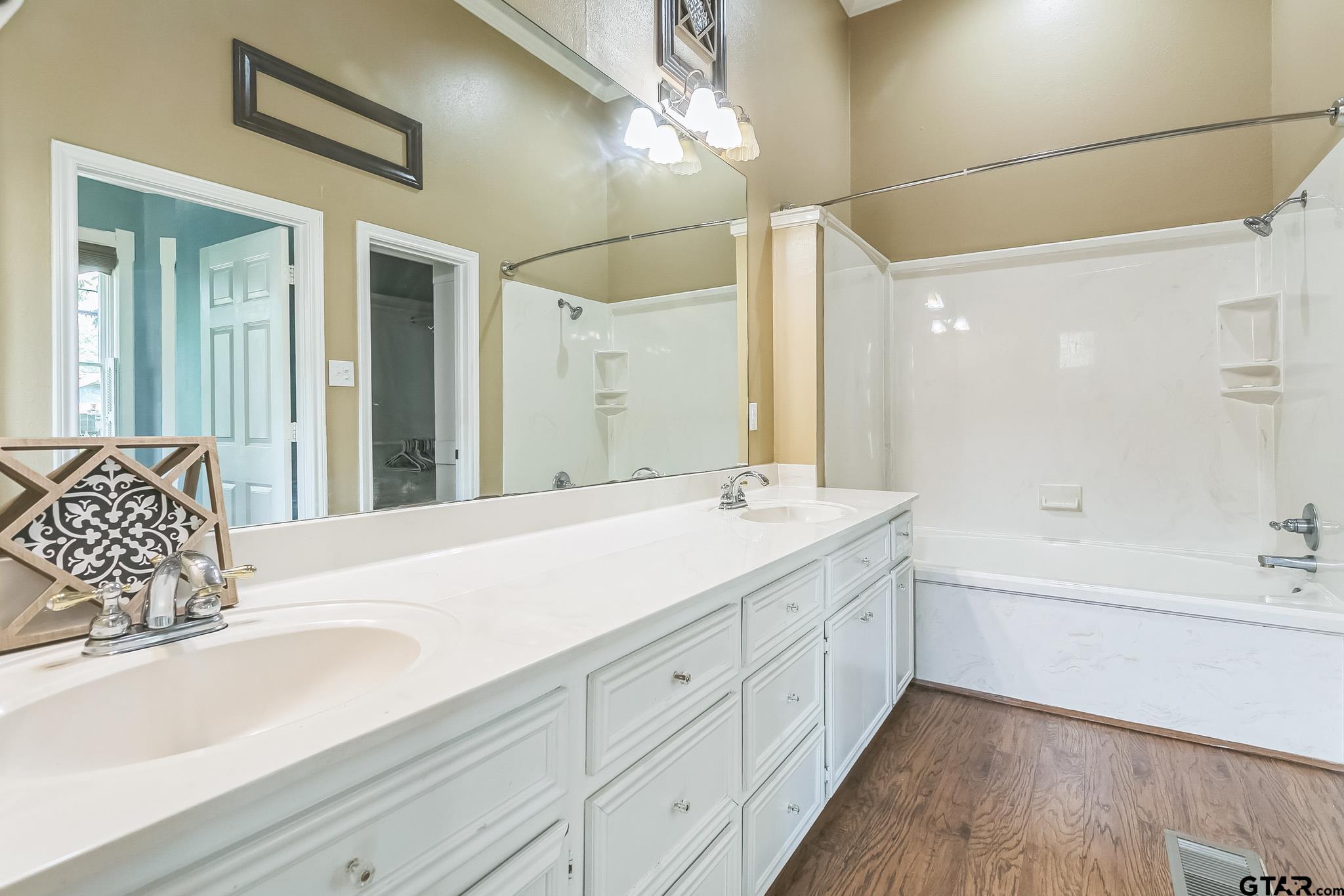 293 South Barron Rusk, TX 75785 - Photo 26 of 30 a spacious bathroom with sinks mirror and a bathtub