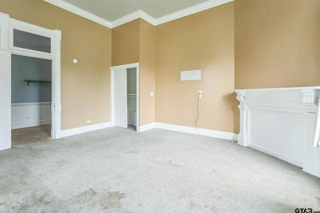 a view of a hallway with wooden floor and closet