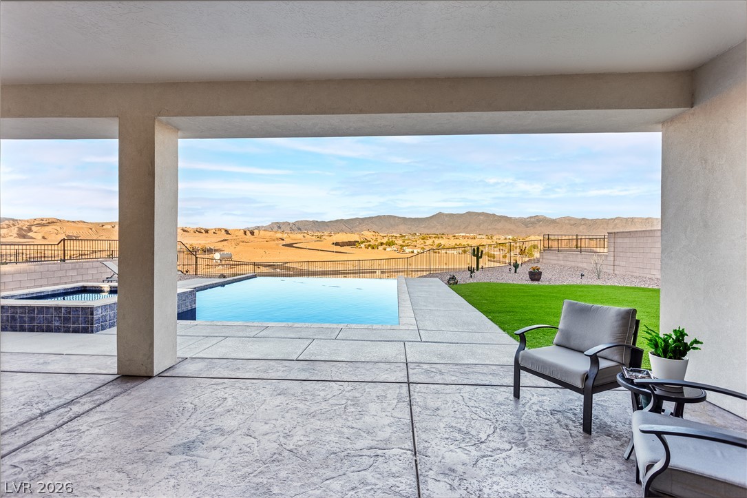 1460 Blue Ridge Trail Mesquite, NV 89027 - Photo 25 of 39 An impressive inground pool and spa with a stunning desert and mountain backdrop.