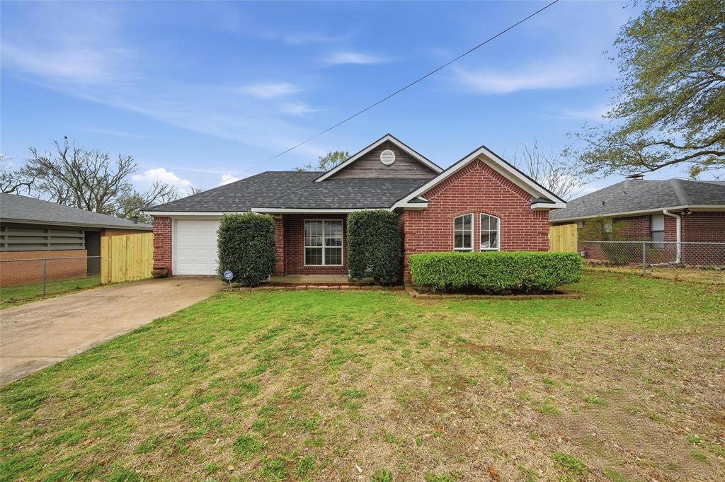 2418 Loy Lake Road Denison, TX 75020 - Photo 1 of 23 a front view of a house with a garden and yard