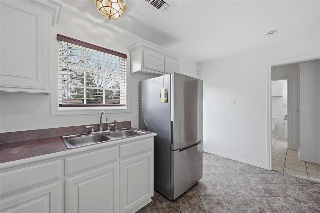 2418 Loy Lake Road Denison, TX 75020 - Photo 11 of 23 a kitchen with stainless steel appliances granite countertop a refrigerator and a sink