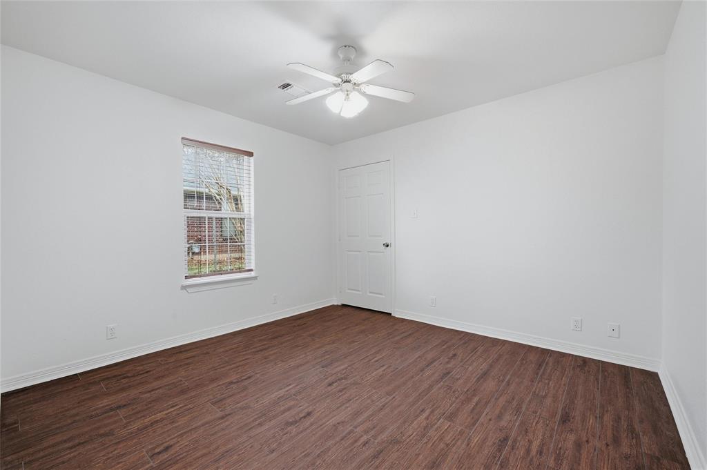 2418 Loy Lake Road Denison, TX 75020 - Photo 12 of 23 an empty room with wooden floor and windows