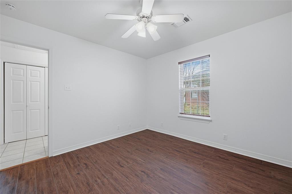 2418 Loy Lake Road Denison, TX 75020 - Photo 13 of 23 an empty room with wooden floor chandelier fan and windows
